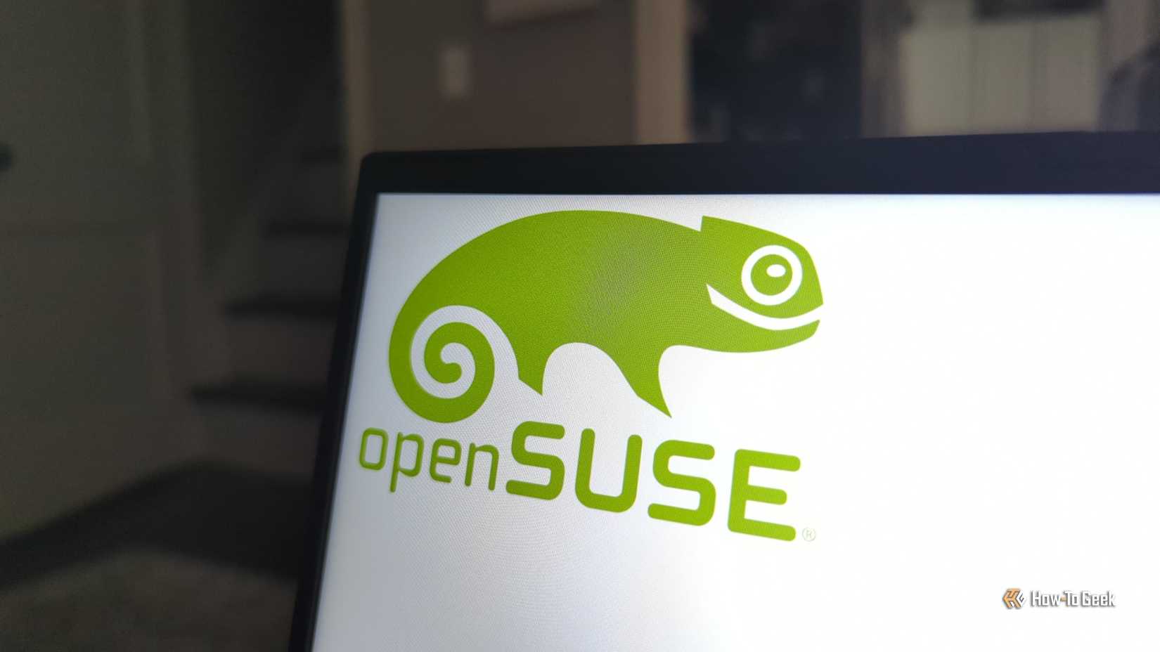 The openSUSE Linux logo on a laptop panel.
