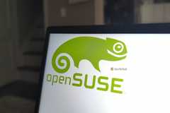 The openSUSE Linux logo on a laptop panel.
