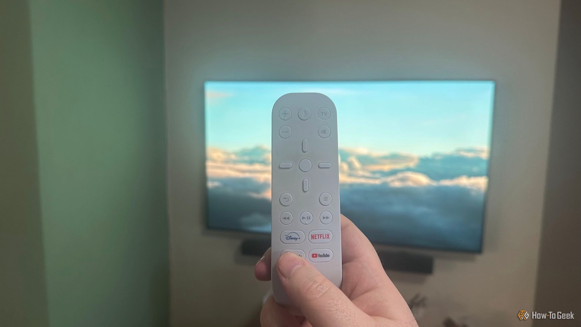 The Sony PS5 Media remote with a TV in the background.