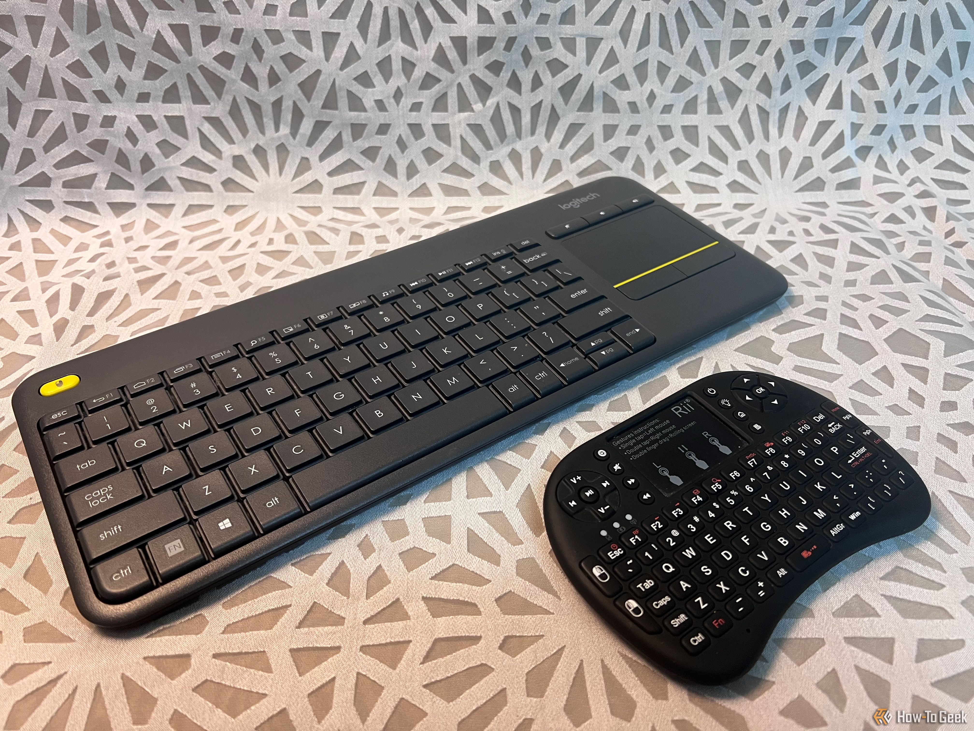 An image of two wireless keyboard and mouse combos, one a Logitech, one is Rii mini.