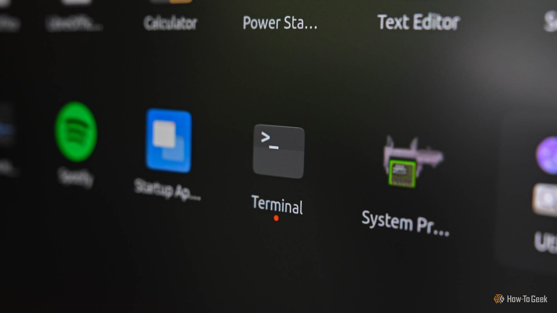 Closeup of a computer screen with a Linux terminal icon in the center.