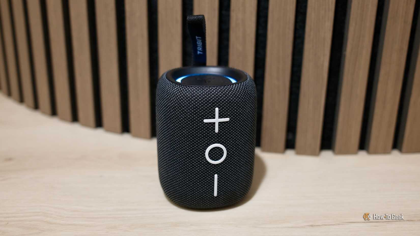Tribit StormBox Mini+ in black sitting on the floor.