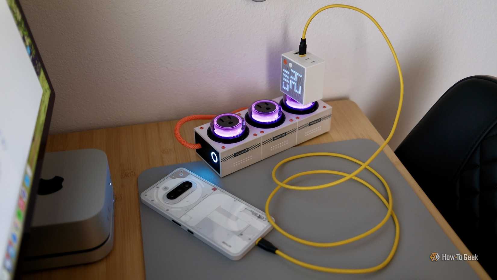 Genki Moonbase with a charger plugged in charging a phone.