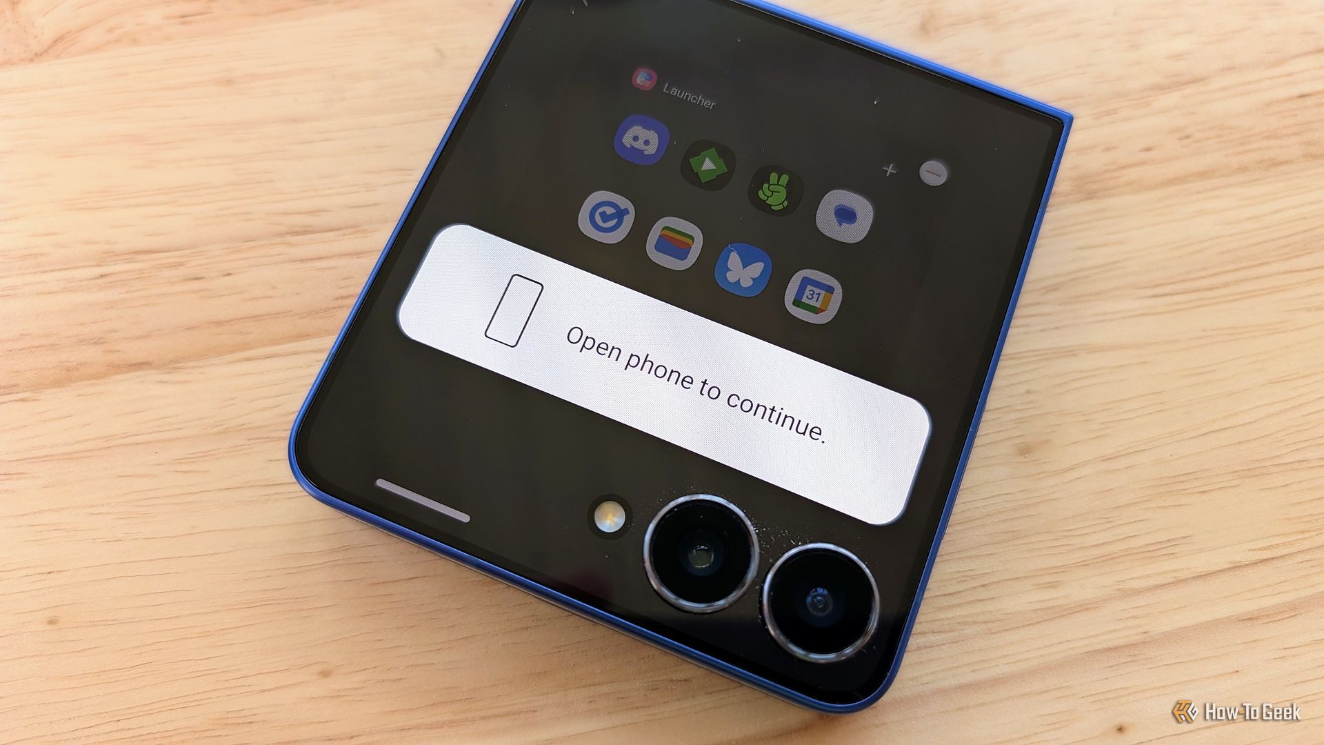 Samsung Galaxy Z Flip 7 with a message that says "Open on phone to continue."