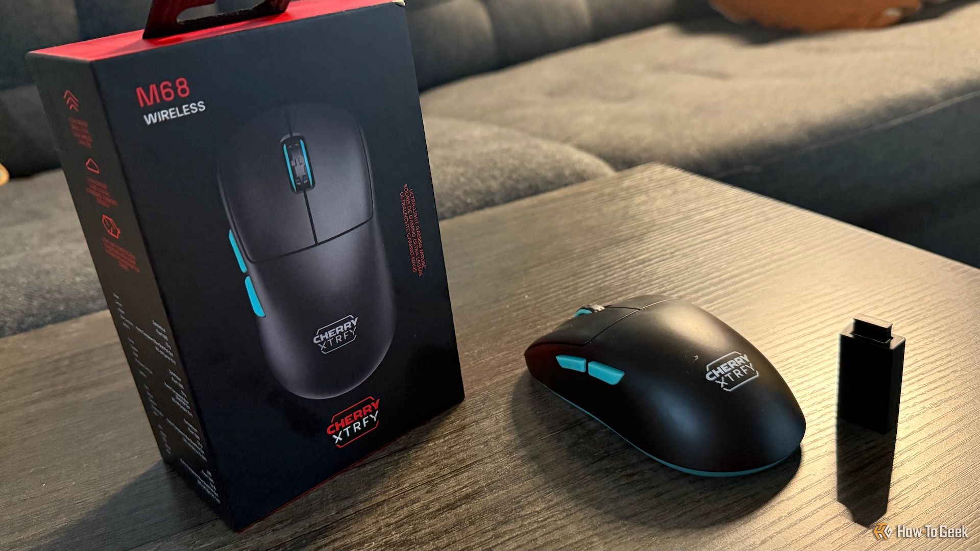 The Cherry XTRFY M68 Wireless, its 2.4 GHz receiver and dongle, and its box.
