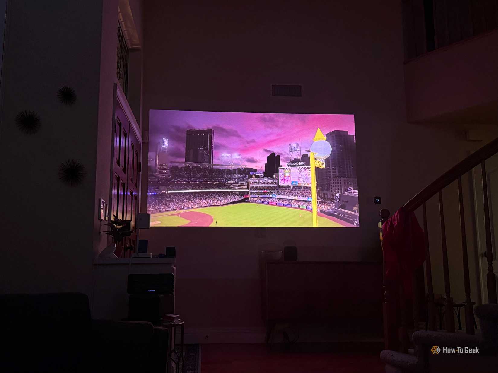 Image of a stadium projected on a wall inside.