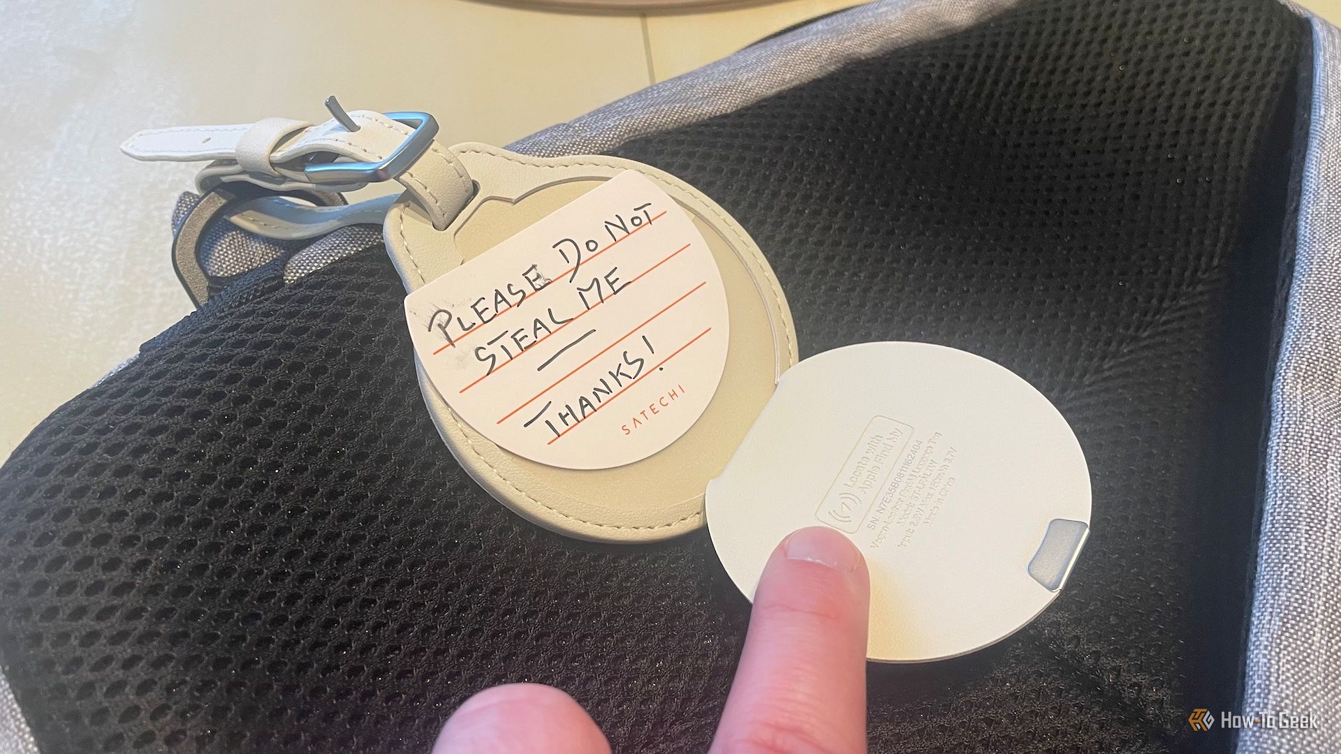 The Satechi Findall with baggage label attached to a bag with a useful note. 