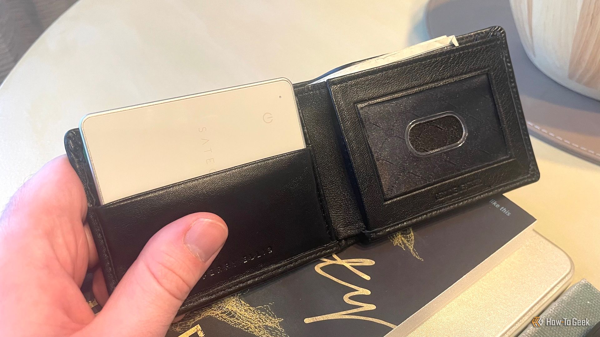 The Satechi Findall wallet card inside a wallet pocket.